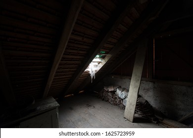 Inside The Attic Of An Old House With Cobwebs.