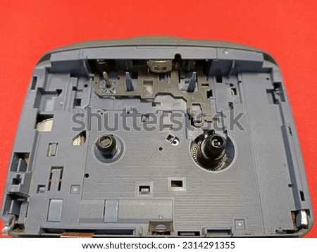 the inside of a broken Walkman cassette player