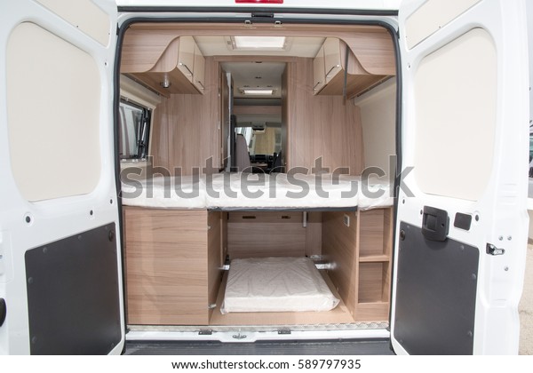 The inside of a camping car with its tidying up\
and its comfort