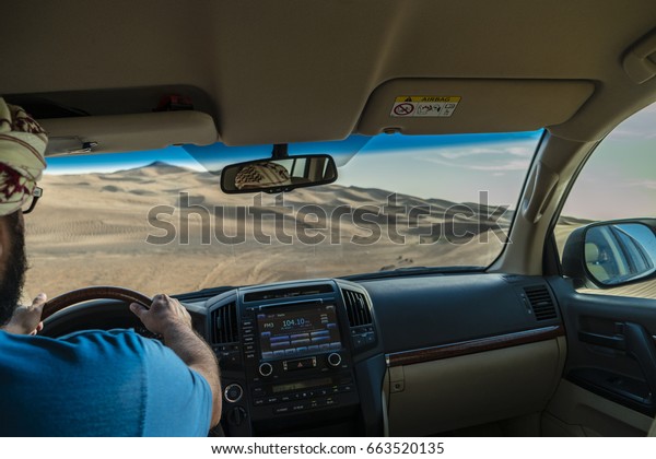 inside a car 4x4 at dubai desert safari,Yellow\
desert dunes and sky,Red sand Arabian desert near Dubai, United\
Arab Emirates,Huge dunes of the\
desert