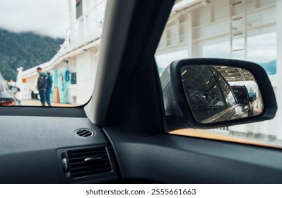 Inside the car aboard Norwegian ferry, surrounded by other vehicles and campers. Scene capture essence of travel and adventure. Traveling and car rental concept.
