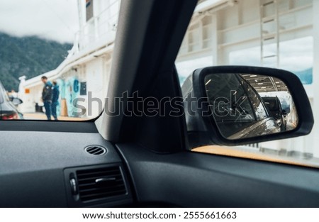 Inside the car aboard Norwegian ferry, surrounded by other vehicles and campers. Scene capture essence of travel and adventure. Traveling and car rental concept.