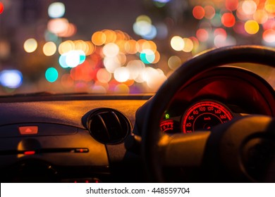 Inside Car With Bokeh Lights From Traffic Jam On Night Time For Background.