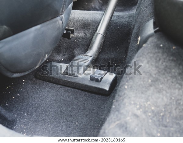 inside\
the car cleaning with a vacuum cleaner\
close-up