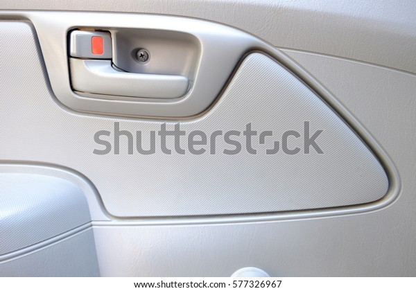 inside car\
door lock beige color close up,\
background
