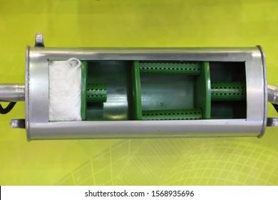 Inside Car Exhaust Silencer Model In Cut Close Up On Green Background, Perforated Tubes, Glass Wool Filler And Partition Walls