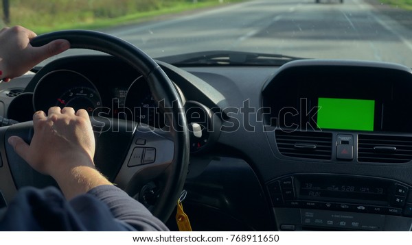 Inside a car. A GPS module is on. Green screen.\
Close-up shot