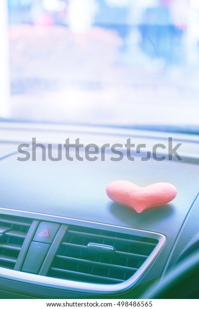 Inside the car\
with Pink heart with light\
filter