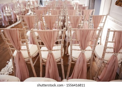 Inside A Ceremony Room With Chairs Decorated With Vintage Style Blush Pink Material