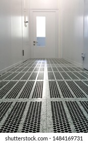 Inside The Cleanroom Of Semiconductor Manufacturing.Hallway With Raised Floor And Door In Cleanroom For Pharmaceutical Or Electronic Industry.