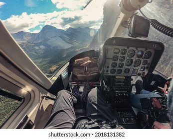 Inside Of Cockpit A Helicopter Flying Over Rocky Mountains In National Park. POV Shot