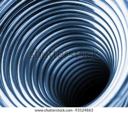 Inside the coiled metal springs. Toned in blue
