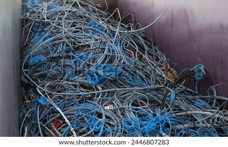 Inside a container with bundles of old copper and PVC electrical cables for recycling
