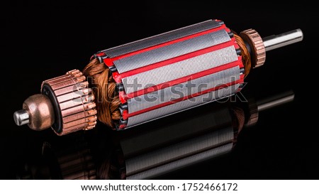 Inside of DC motor rotor with reflection on black background. Artistic still life of dismantled rotary electrical engine. Commutator, wire winding and transformer sheets on shaft. Full depth of field. Stok fotoğraf © 