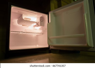 inside the empty fridge in the room with dim light