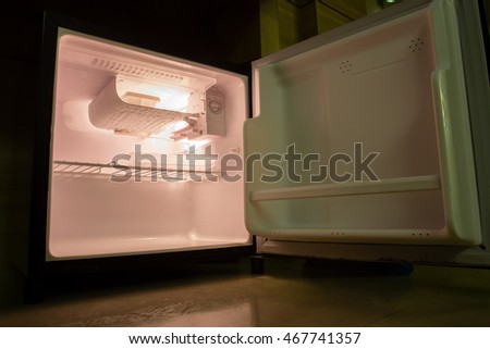 inside the empty fridge in the room with dim light