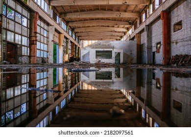 Inside Of Flooded Dirty Abandoned Ruined Industrial Building With Water Reflection.