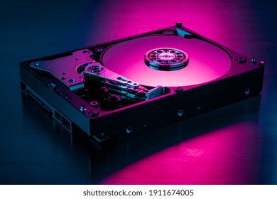 Inside of hard disk drive on the metal brushed background.