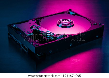 Inside of hard disk drive on the metal brushed background.
