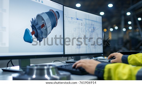 Inside the Heavy Industry Factory Close-up\
Footage of  Industrial Engineer\'s Hands Working on the Personal\
Computer with Two Monitors Designing Turbine/ Engine in 3D, Using\
CAD Program.