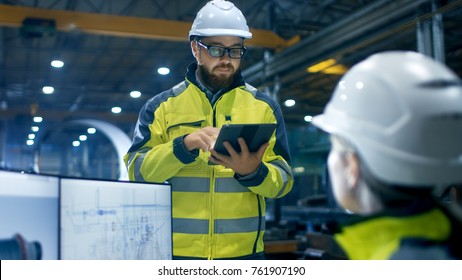 Inside the Heavy Industry Factory Female Industrial Engineer Works on Personal Computer She Designs 3D Engine Model, Her Male Boss Uses Tablet Computer. - Shutterstock ID 761907190