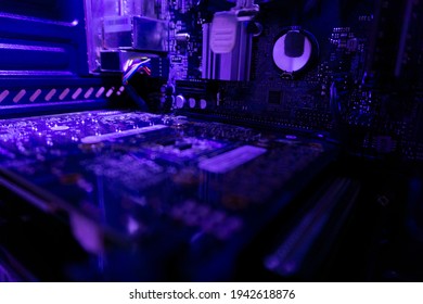 Inside A High Performance Computer. Computer Circuit Board And CPU Cooling Fans Illuminated By Internal LEDs Inside A Server Class Hardware.