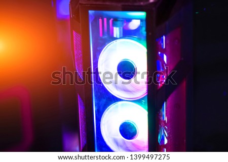 Inside a high performance computer. Computer circuit board and CPU cooling fans illuminated by internal LEDs inside a server class computer.