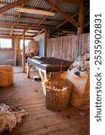 Inside historic shearing shed with corrugated iron roof and wooden flooorboards