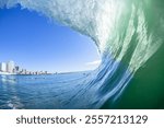 Inside hollow crashing ocean wave tube surfing perspective at Durban beach stadium hotel apartment landscape.