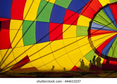 Inside Hot Air Balloon With People Outside.  Colorful Canopy Creates Silhouettes Of People Outside Balloon.