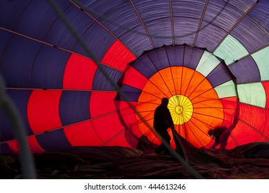 Inside Hot Air Balloon With People Outside.  Colorful Canopy Creates Silhouettes Of People Outside Balloon.