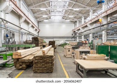 Inside interior factory workshop with stacks of wood for making molds and carpentry machine tools