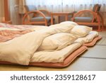 Inside the Japanese style bedroom with two futon mattresses on tatami mat. Luxury Ryokan in Japan.