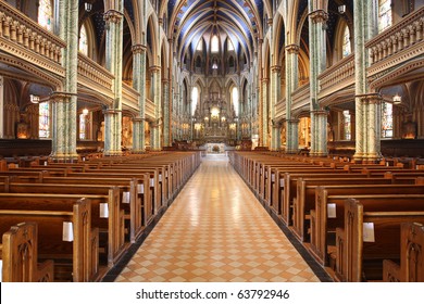 Inside Of  A Large, Modern Church With Pews And Cross Visible