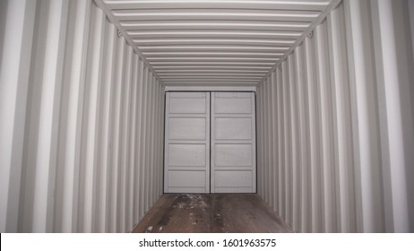 Inside Large Shipping Container. Stock Footage. View From Inside Locked Cargo Container With White Striped Iron Walls. Empty Light And Locked Cargo Trailer Container