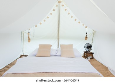 Inside A Large White Tent Camp With Bed And Interior Furnishings