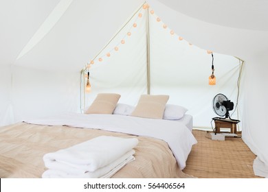 Inside A Large White Tent Camp With Bed And Interior Furnishings