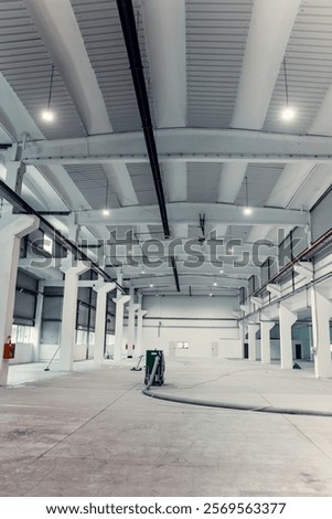 Inside a logistics center or warehouse undergoing maintenance with a Floor Shot Blasting Machine as it diligently rejuvenates the flooring.
