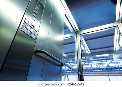 Inside Metal And Glass Elevator In Modern Building , The Shiny Buttons And Railings