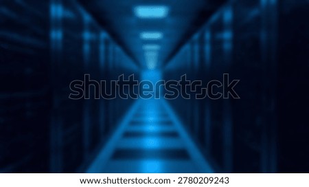 Inside a modern data center, a long corridor with server racks and blue lighting creates a futuristic atmosphere. The image showcases technology and data storage.
