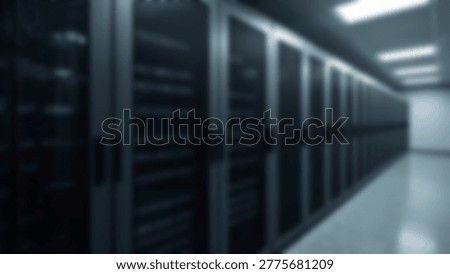Inside a modern data center, rows of server racks house powerful computing equipment, essential for data storage and processing. The server room is well-lit and organized.