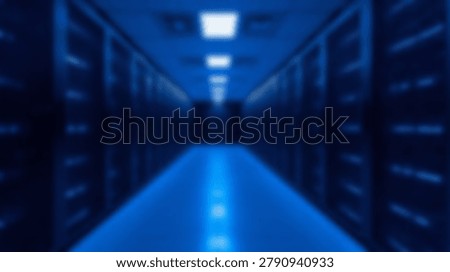 Inside a modern data center, servers are arranged in rows with blue lighting. The blurred background creates a sense of depth and focus on the technology.
