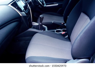 the inside of new car passenger room with velvet seat ,gear sticks ,hand brake ,multi media player and steering wheel