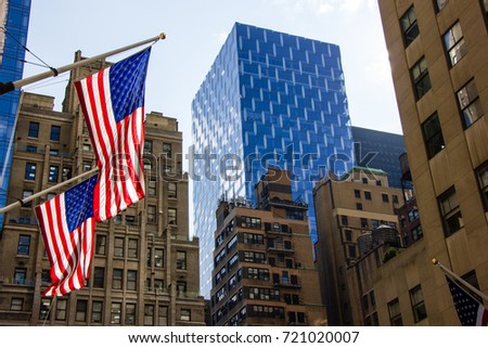 Inside New York City I was walking through the street and made this photo of waving flags with this futuristic looking building in the back.