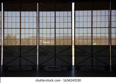 Inside An Old Airplane Hanger. Airplane Hanger Windows And Sliding Doors. 
Inside Of A Airplane Hanger For Storage And Events Or Projects, 