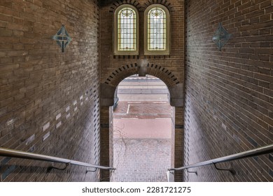 the inside of an old building with brick walls, arched windows and metal railings that lead up to it - Shutterstock ID 2281721275