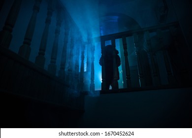 Inside Of Old Creepy Abandoned Mansion. Silhouette Of Horror Baby Ghost Standing On Castle Stairs To The Basement. Horror Halloween Concept