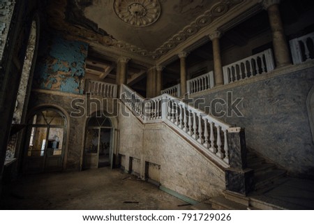 Inside of old creepy abandoned mansion. Staircase and colonnade. 