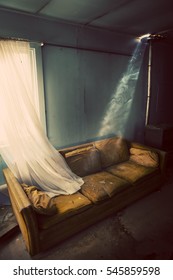 Inside Old Living Room With Broken Glass And Worn Out Couch.  Image Is Treated For A Dated Vintage Feel.