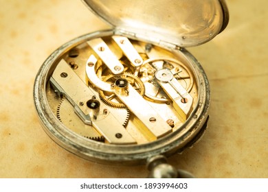 Inside of old pocket watch. Selective focus on centre of clocks mechanism. 